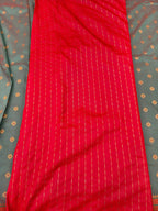 Red silk saree with fine vertical striped weave and smooth patterned drape