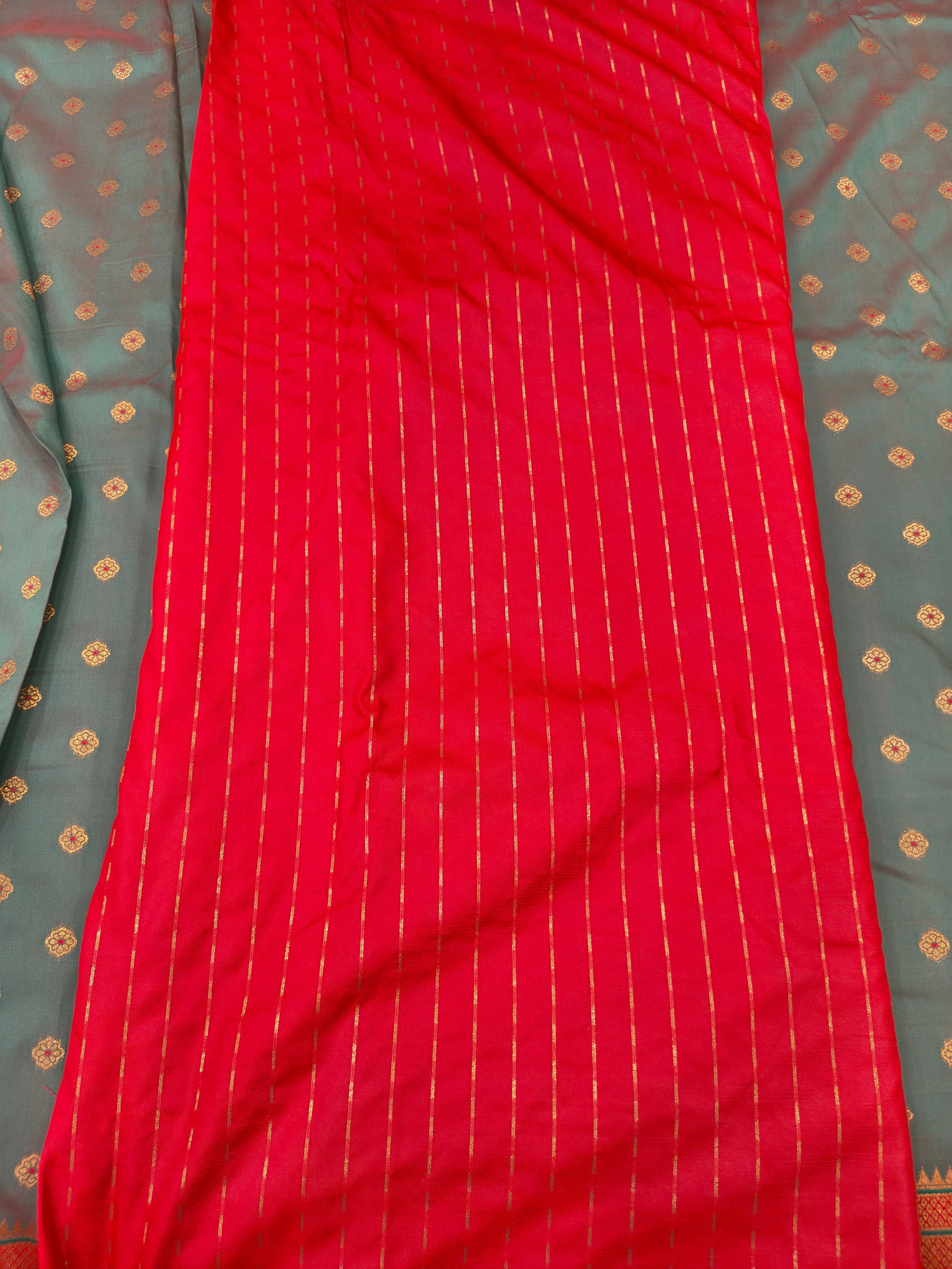 Red silk saree with fine vertical striped weave and smooth patterned drape