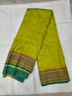 Neon yellow silk saree with red-gold motifs and navy-blue border, teal pallu