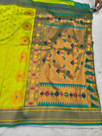 Neon yellow saree with geometric motifs and multicolor border, teal pallu