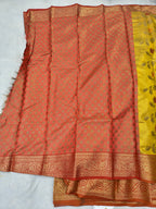 Red silk drape saree with small woven motifs, mustard border, and tassels
