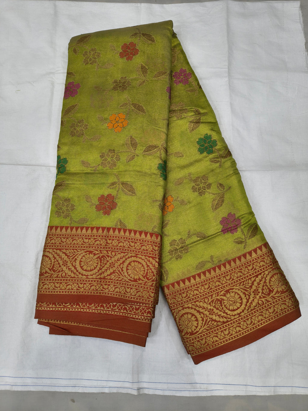 Light green Kanchipuram silk saree with red border and floral vine motifs