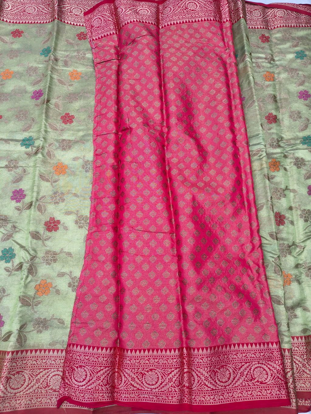Light green and magenta silk saree with floral prints and red zari border