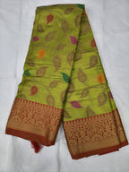 Light green silk saree with leaf motifs and maroon woven border