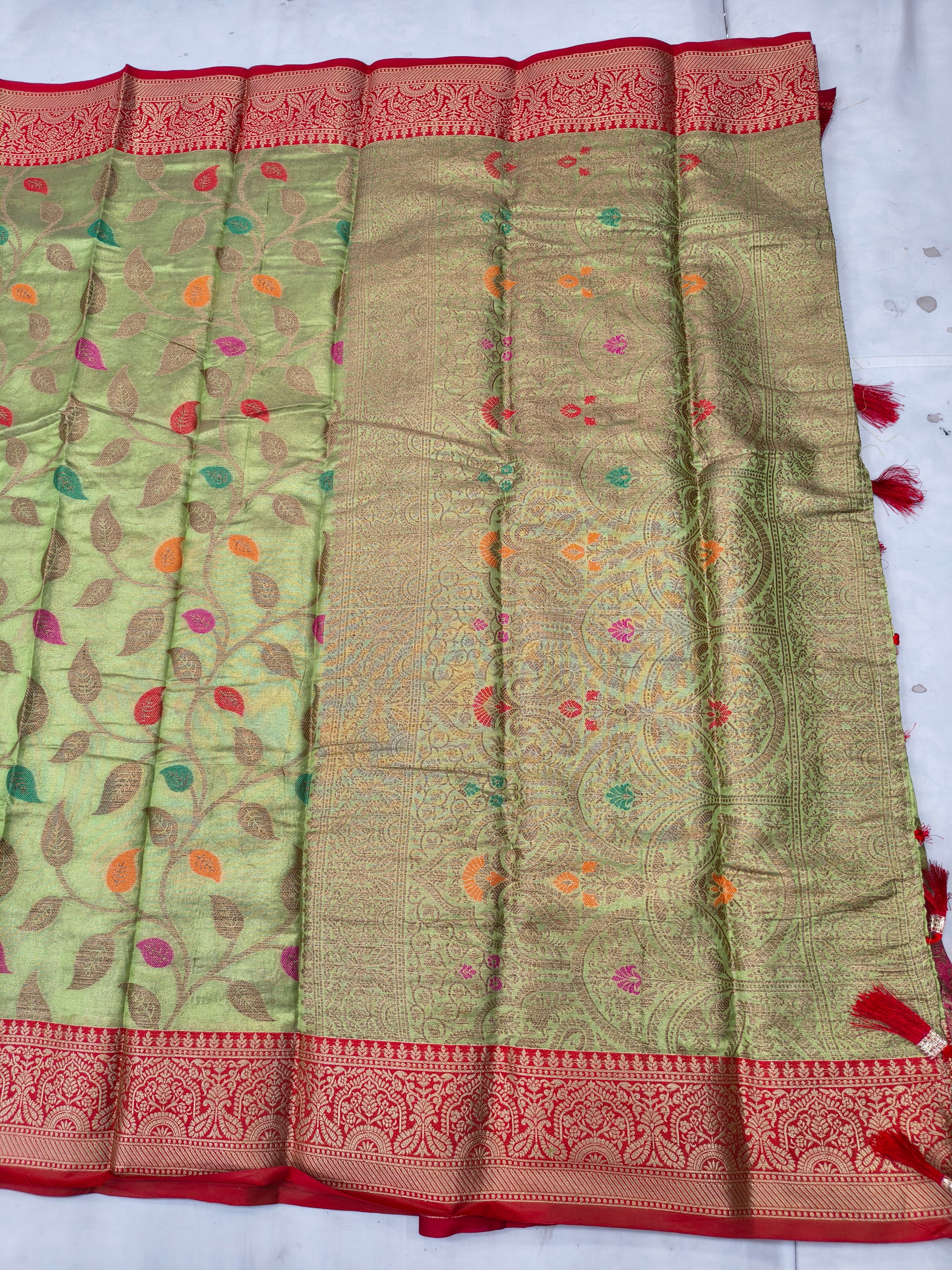 Green and maroon saree with patterned pallu border and contrasting woven band