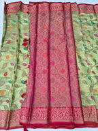 Green saree with leaf print sides and central maroon-pink patterned panel