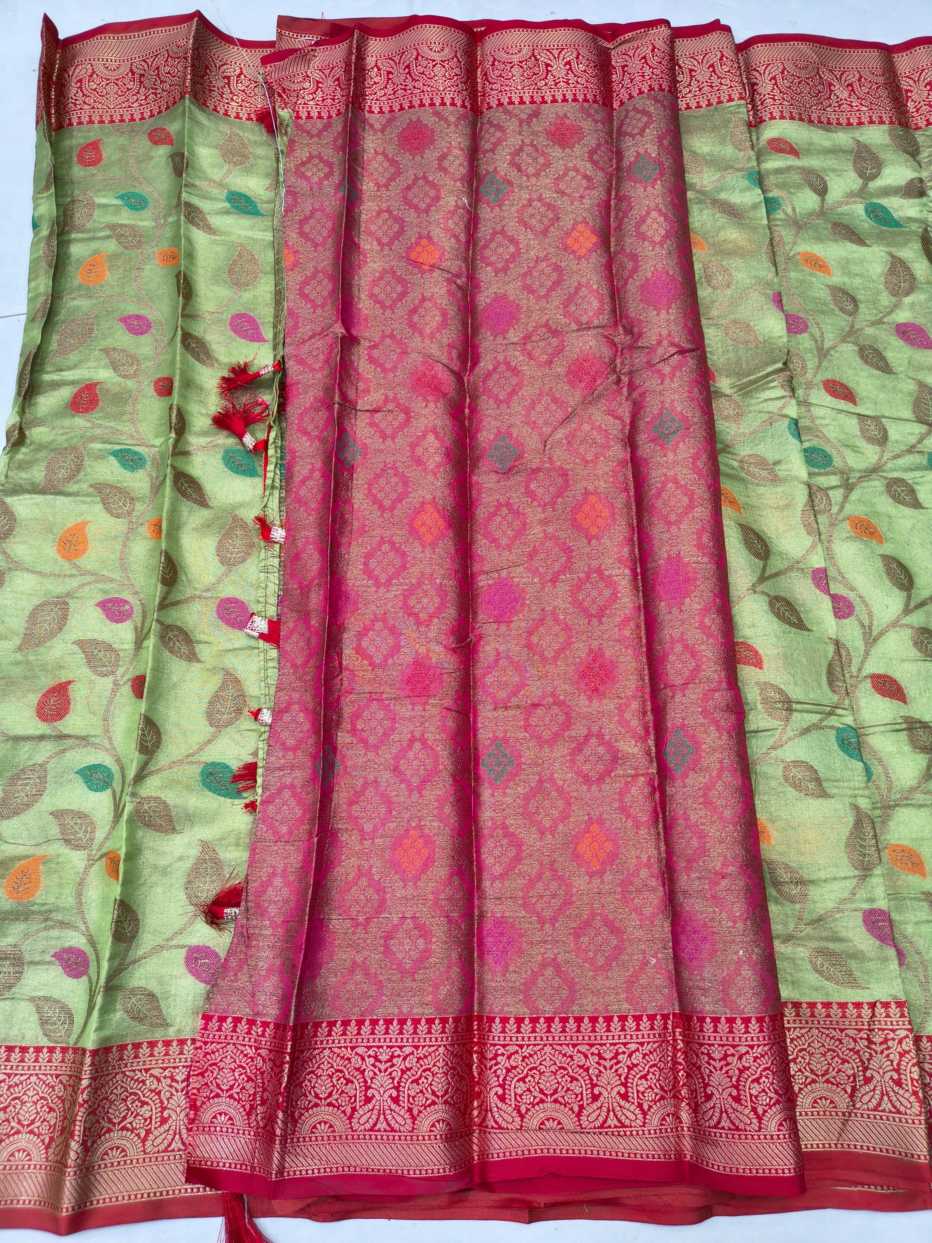 Green saree with leaf print sides and central maroon-pink patterned panel