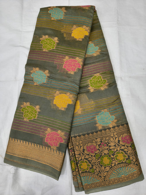 Dark grey silk saree folded, multicolor stripes and floral motifs with gold border