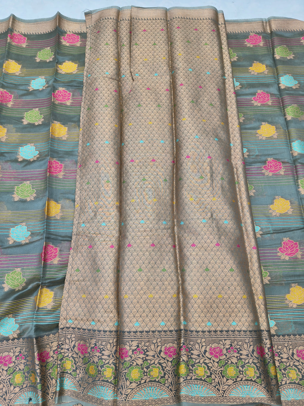 Gold silk saree with tiny dots and multicolor floral border in draped view