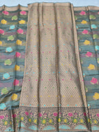 Gold silk saree with tiny dots and multicolor floral border in draped view
