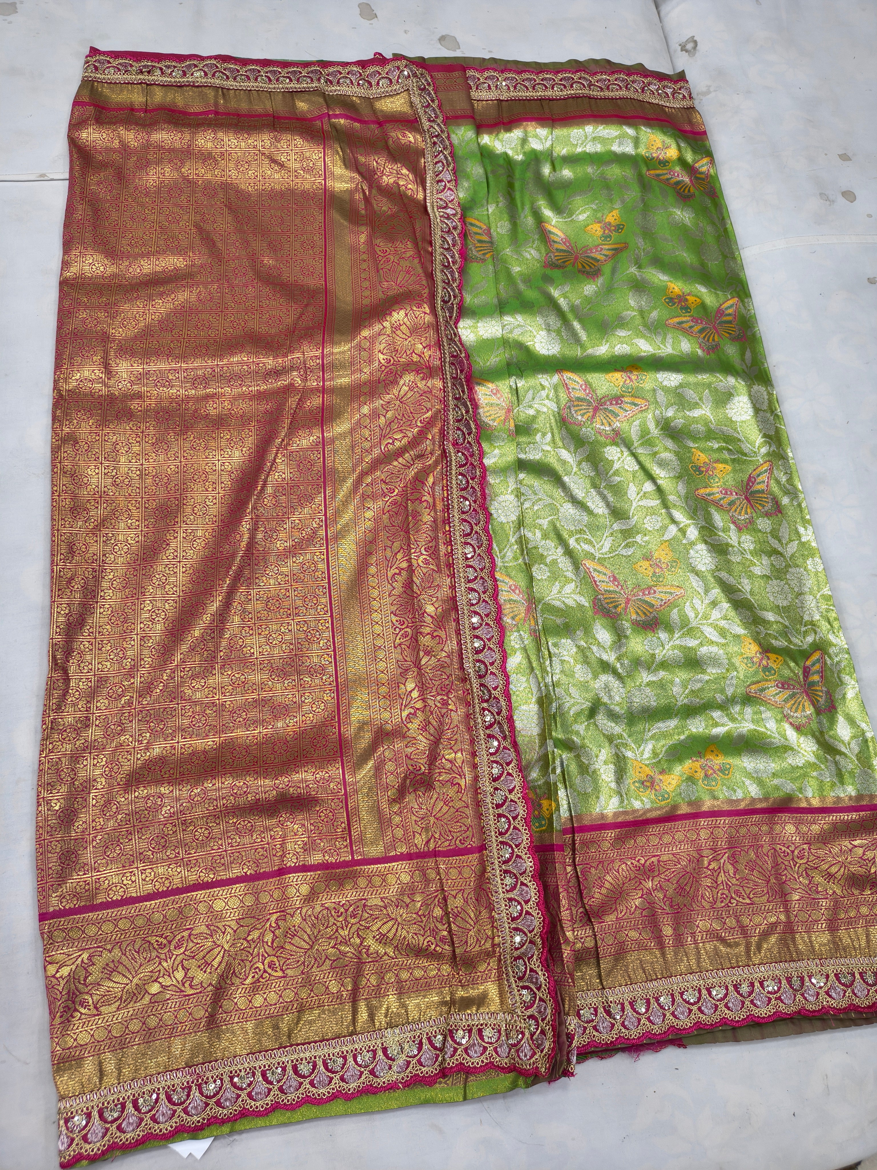 Green and maroon silk saree with woven gold border, pallu section and patterned texture