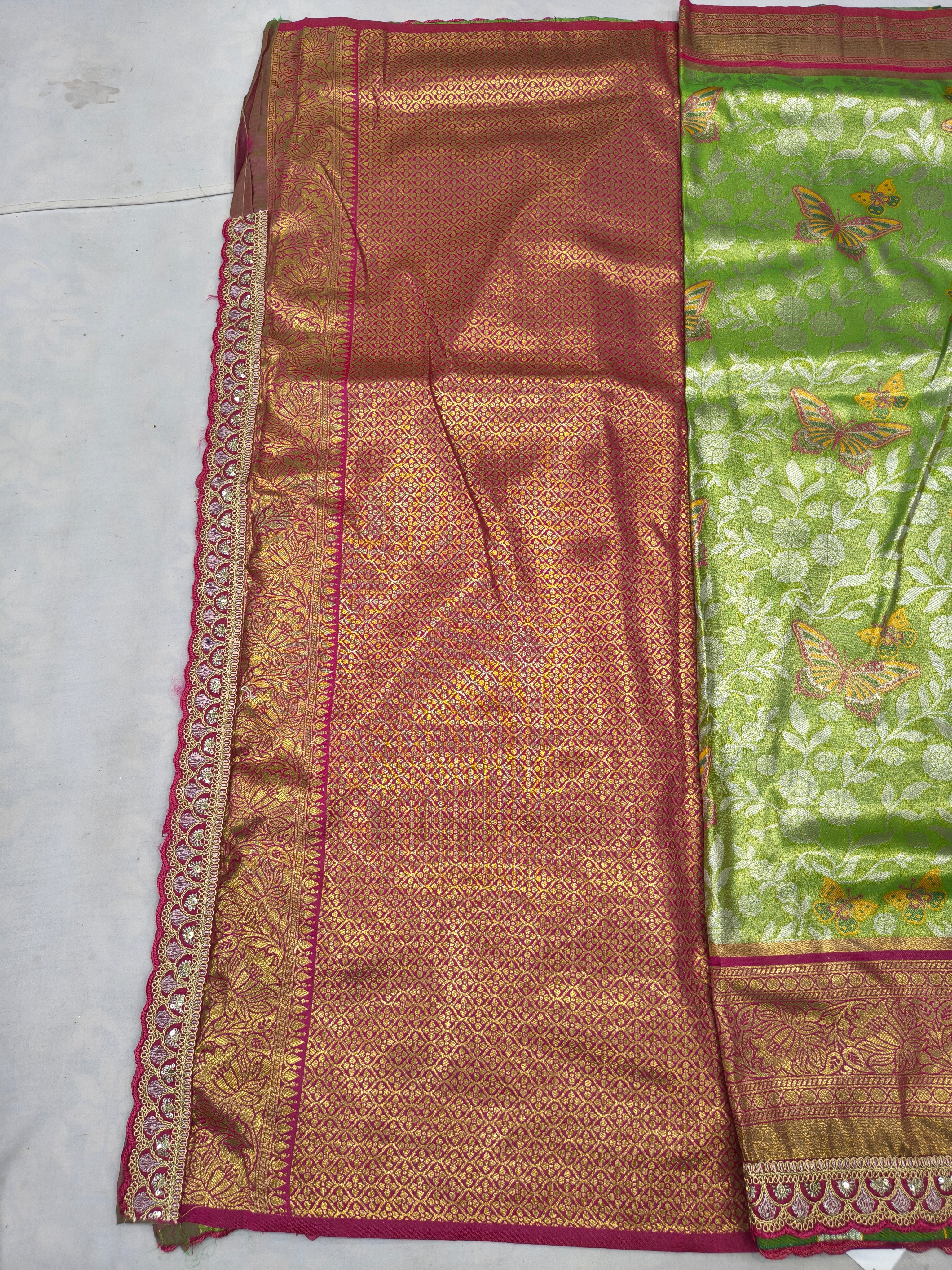 Golden orange and green silk saree with intricate woven panel and decorative border