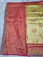 Red and gold Banarasi silk saree with patterned weave and detailed border trim