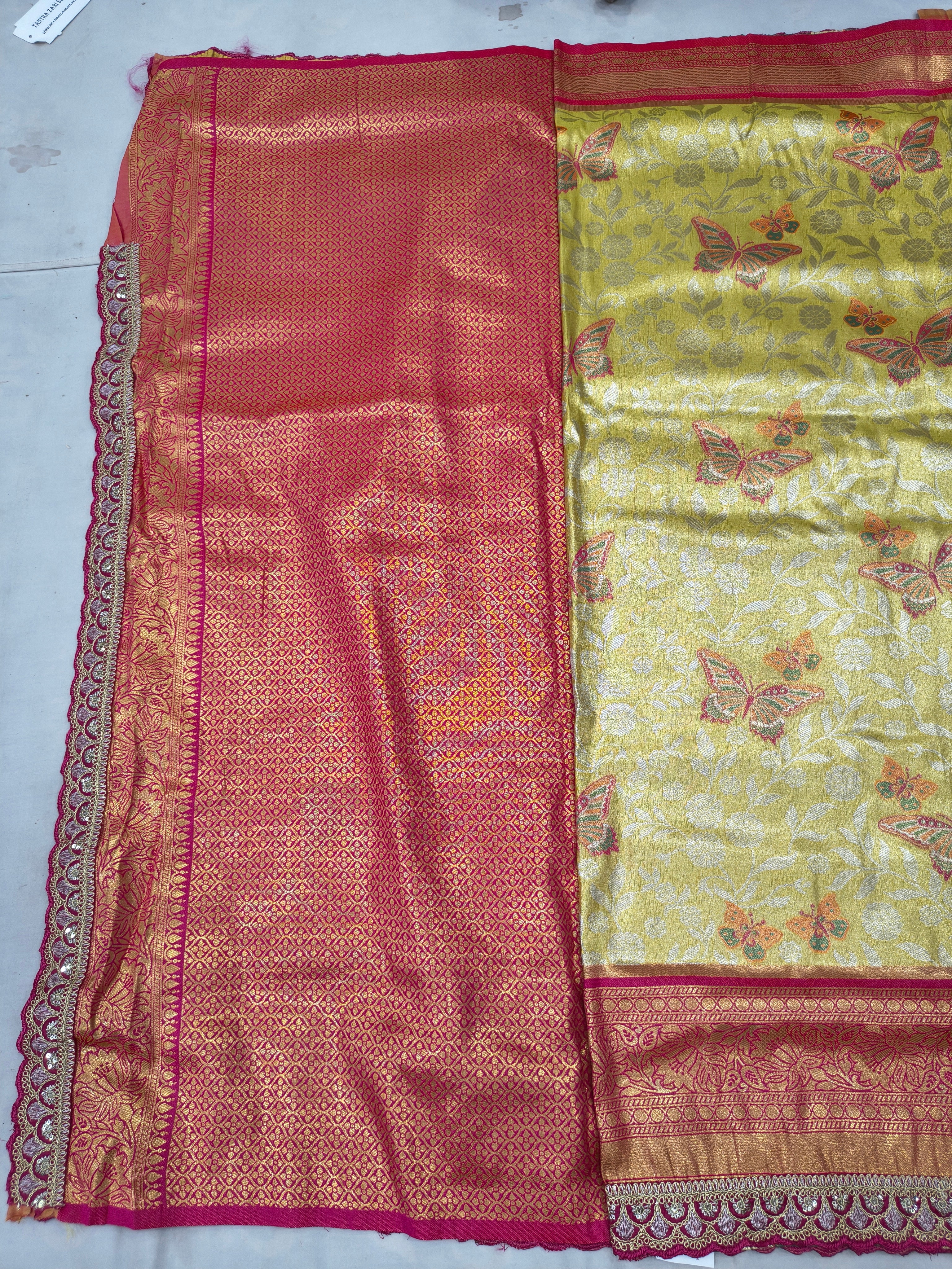 Red and gold Banarasi silk saree with patterned weave and detailed border trim