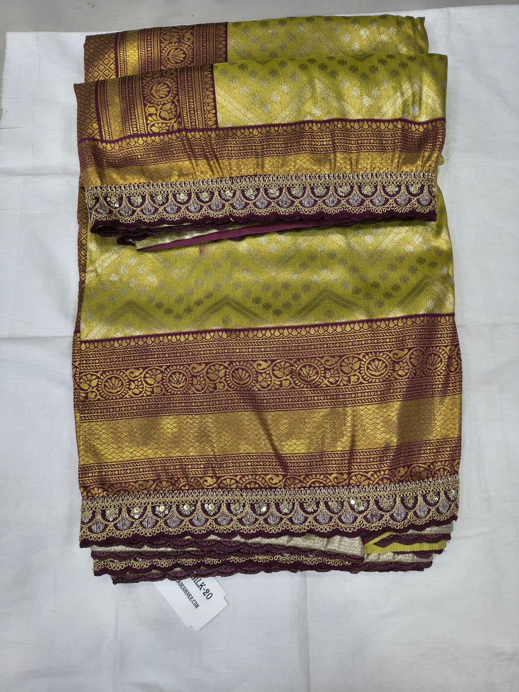 Folded Banarasi silk saree swatch, olive green with maroon-gold border