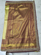 Banarasi silk saree fabric close-up, olive green with maroon border and motifs