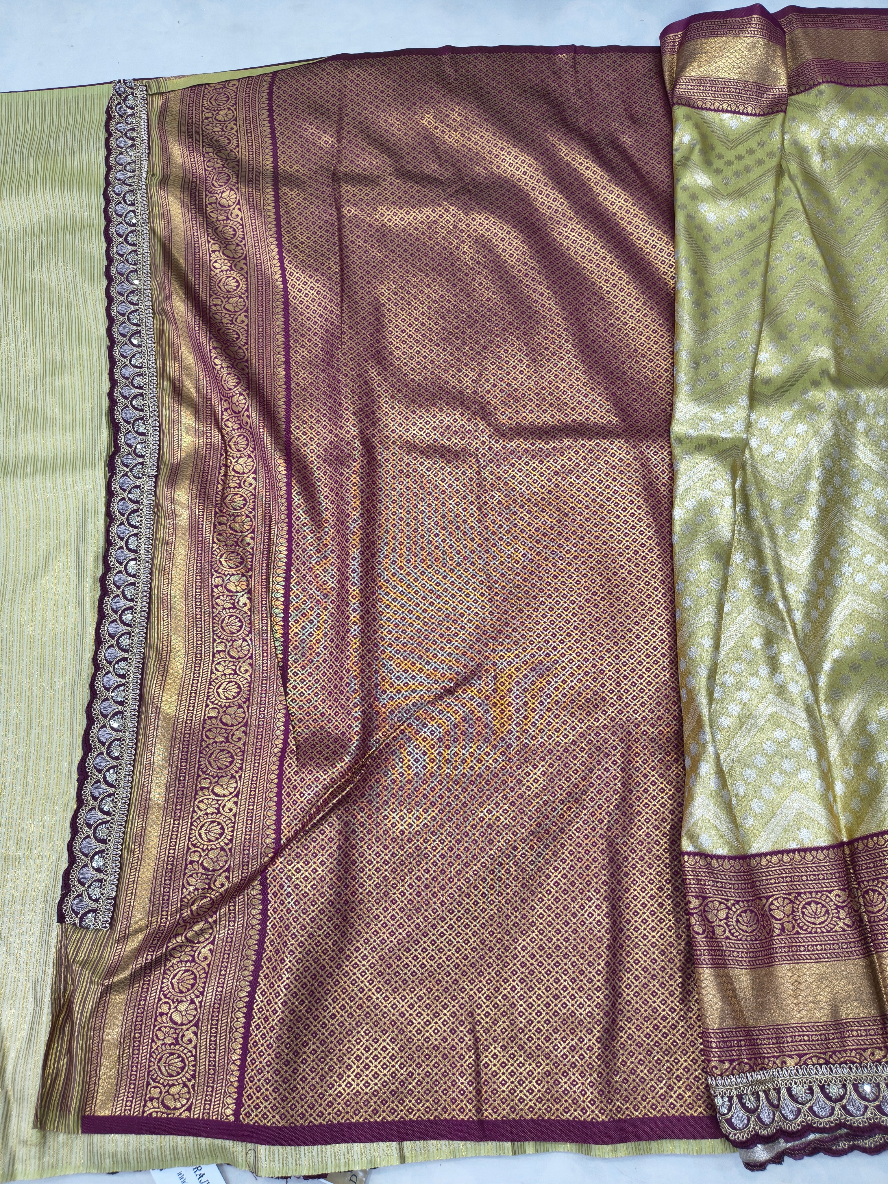 Banarasi silk saree drape close-up, olive green and maroon panel with gold trim