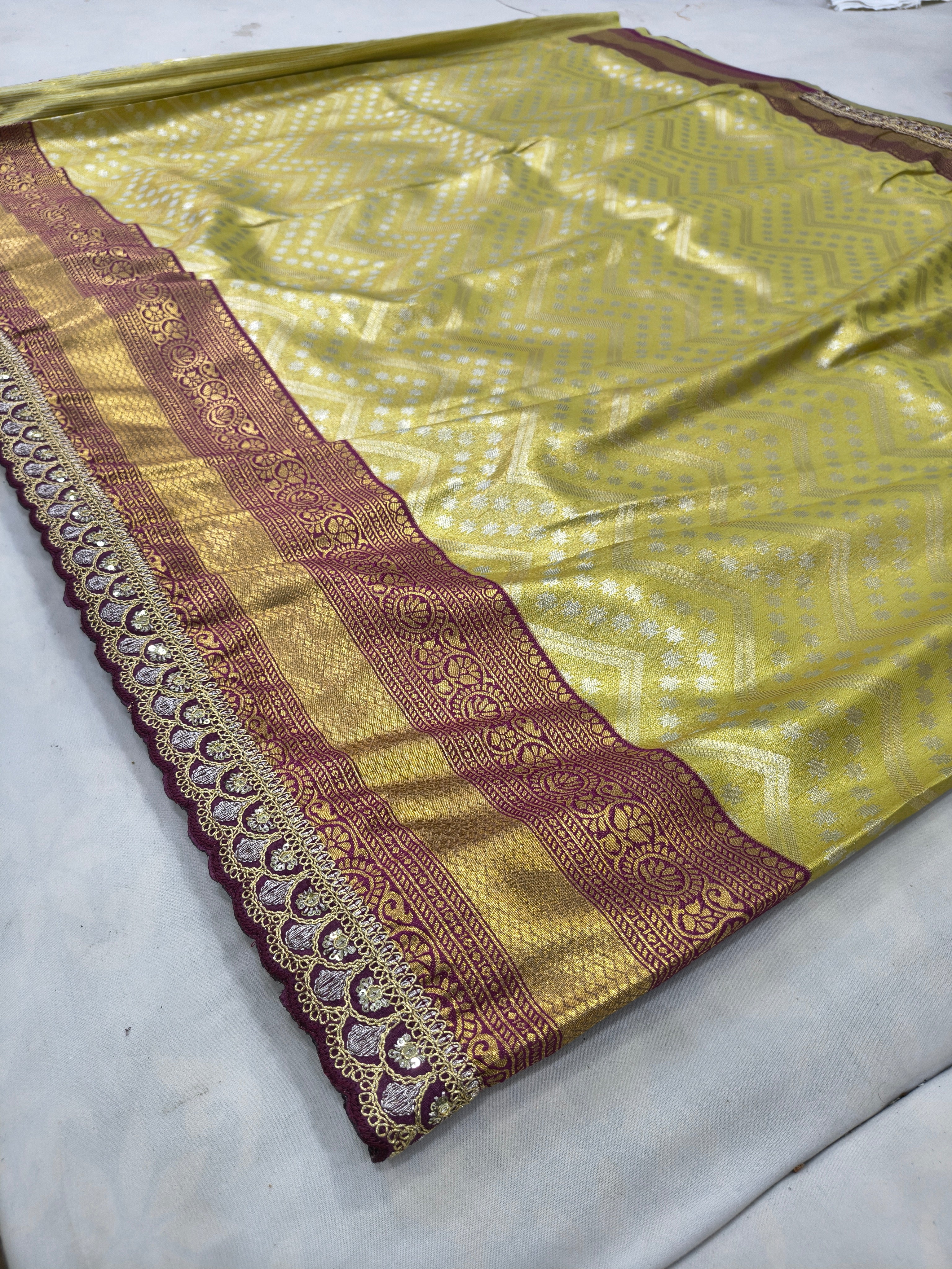 Lying Banarasi silk saree with olive green body, maroon-gold pallu border