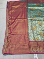 Two-tone saree fabric: maroon-pink center with teal-green side panel and ornate trim
