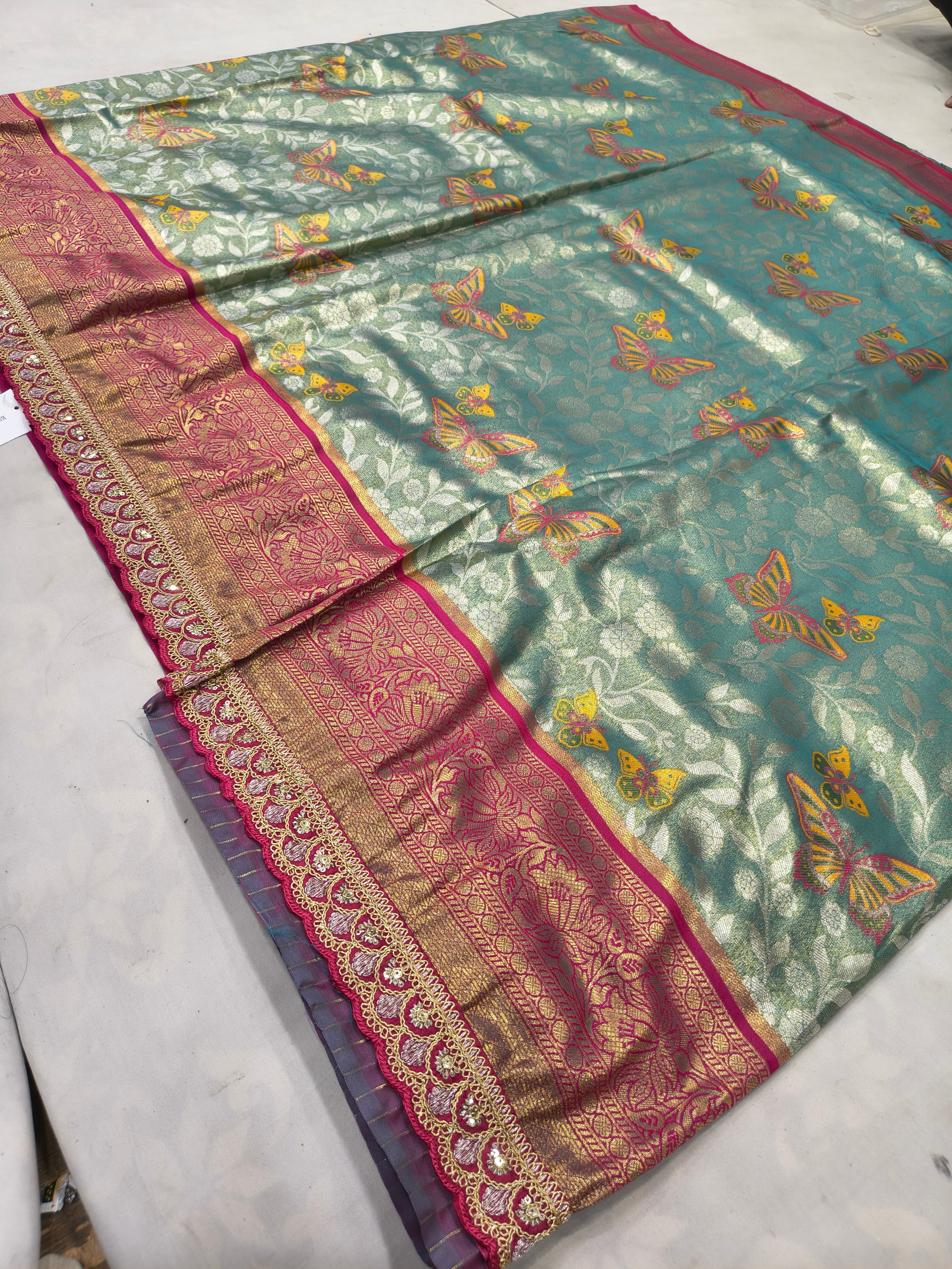 Teal-green Banarasi silk saree with pink border and scattered gold motif work