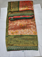 Folded peach and olive Banarasi silk saree with patterned bands and floral prints