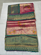 Folded pink and teal Banarasi silk saree with ornate gold border