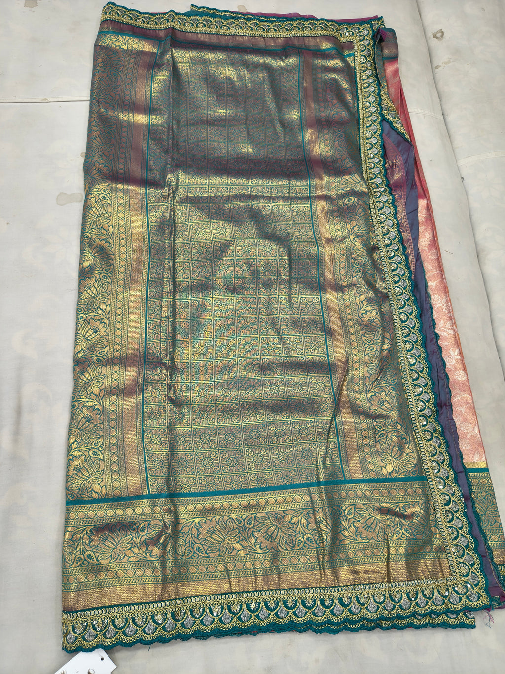 Teal-green Banarasi silk saree section with gold patterned border