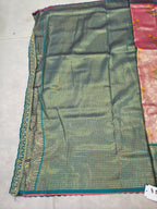 Teal Banarasi silk saree fabric with intricate gold-trim edge
