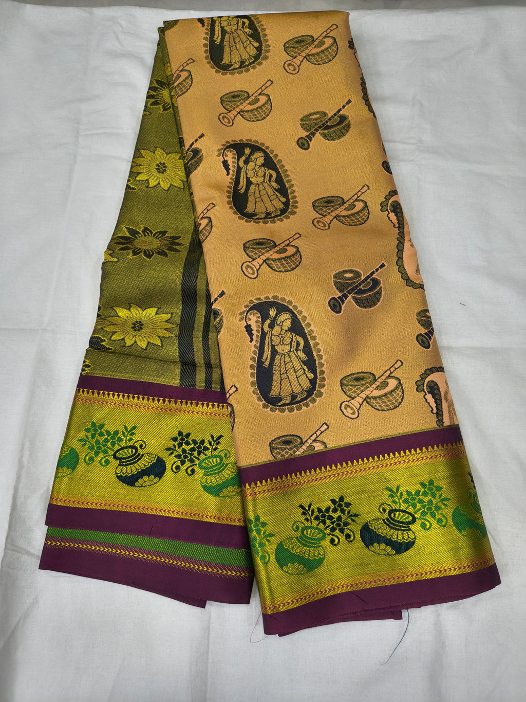 Beige saree with purple and green borders, woven deity motifs and decorative trims