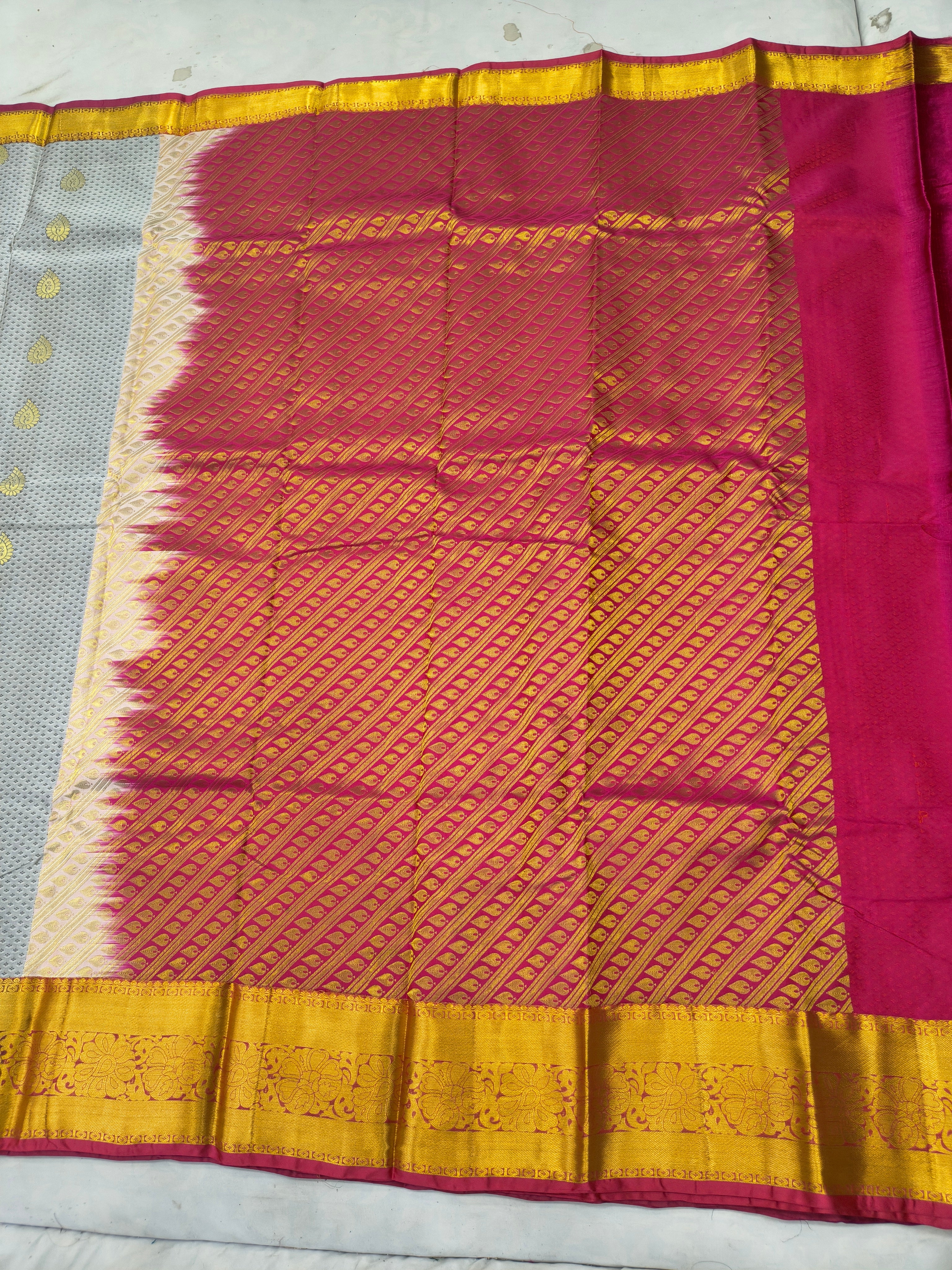 Saree pallu panel in bright magenta with golden grid pattern and mustard border