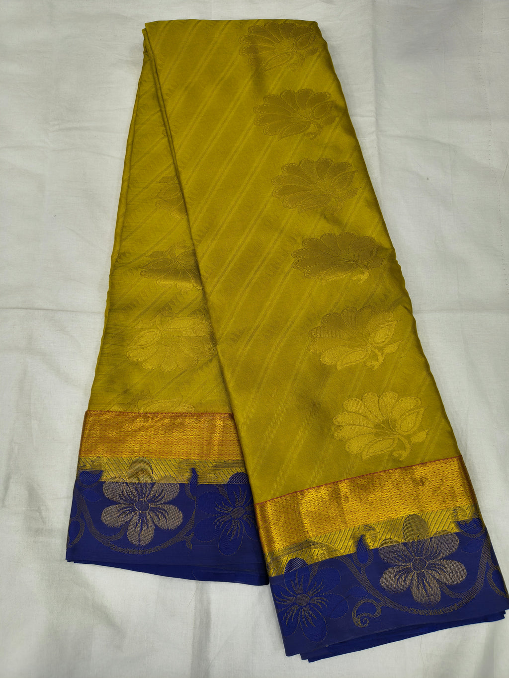 Yellow Kanchipuram silk saree with royal blue border and gold floral motifs