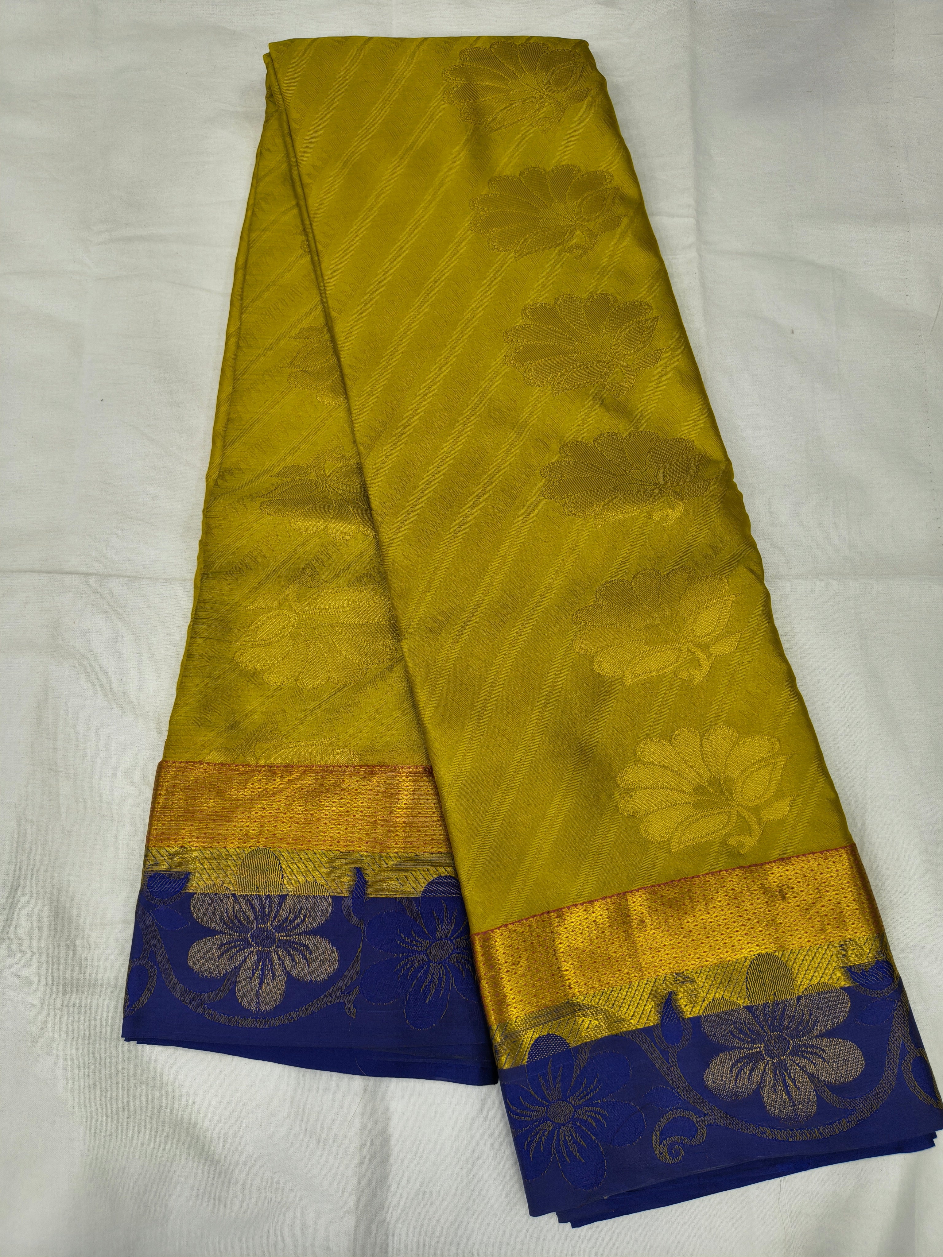 Yellow Kanchipuram silk saree with royal blue border and gold floral motifs