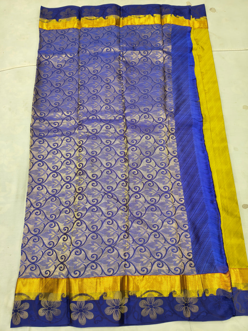 Royal blue saree with yellow border and gold floral swirl motifs