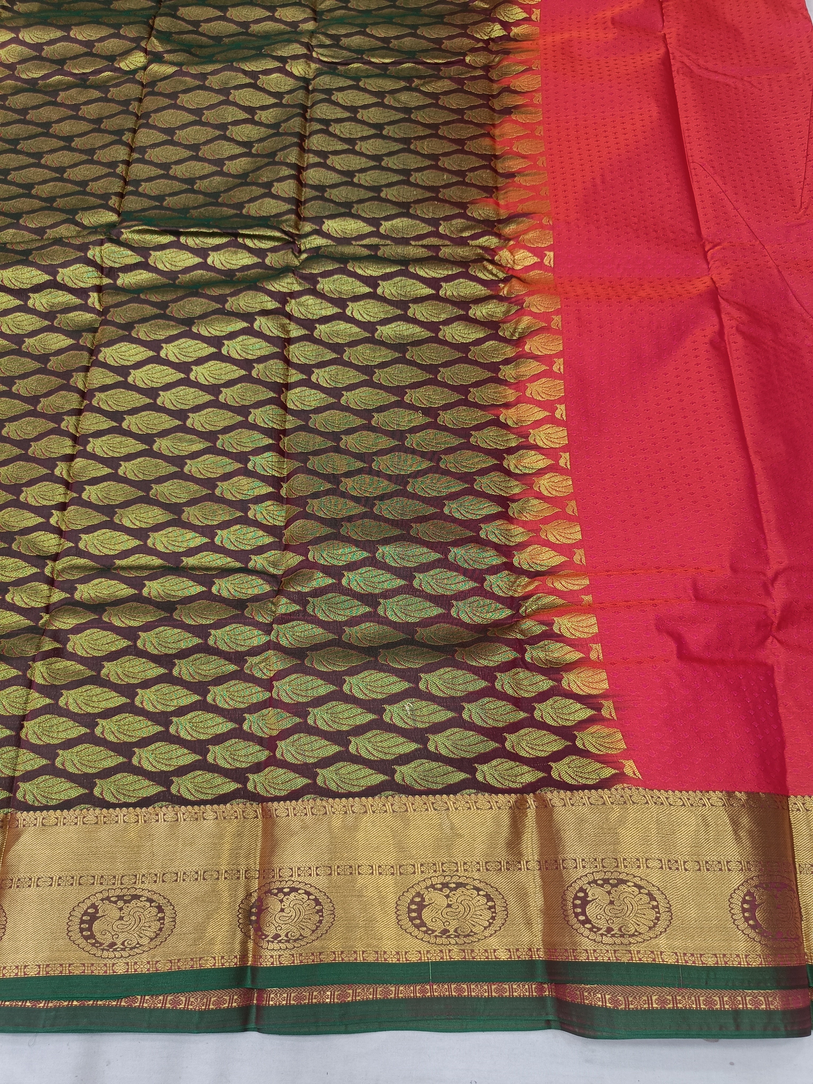 Dark green and gold patterned saree fabric with red panel and gold border