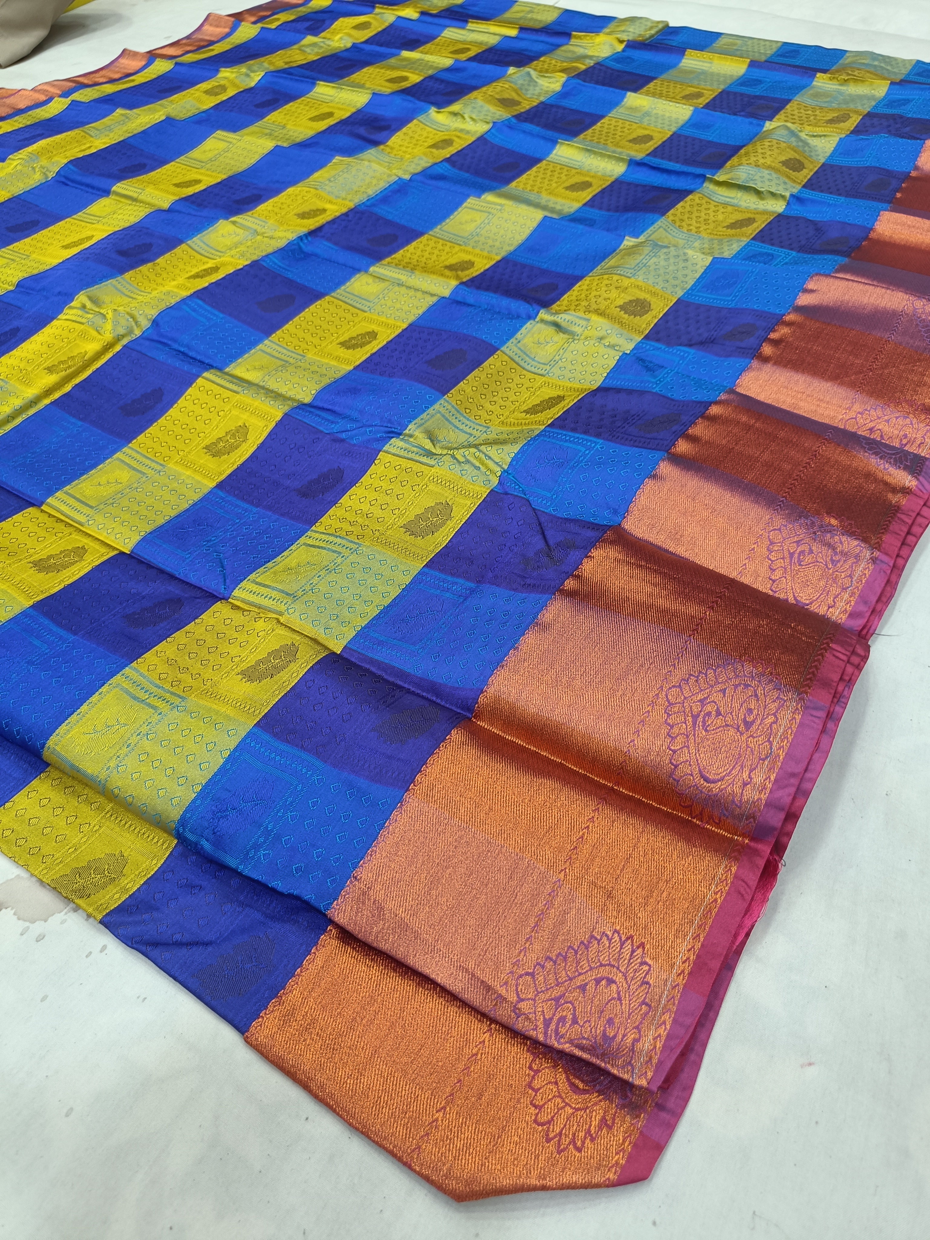 Kanchipuram silk saree fabric with blue and yellow checks and peach pallu panel