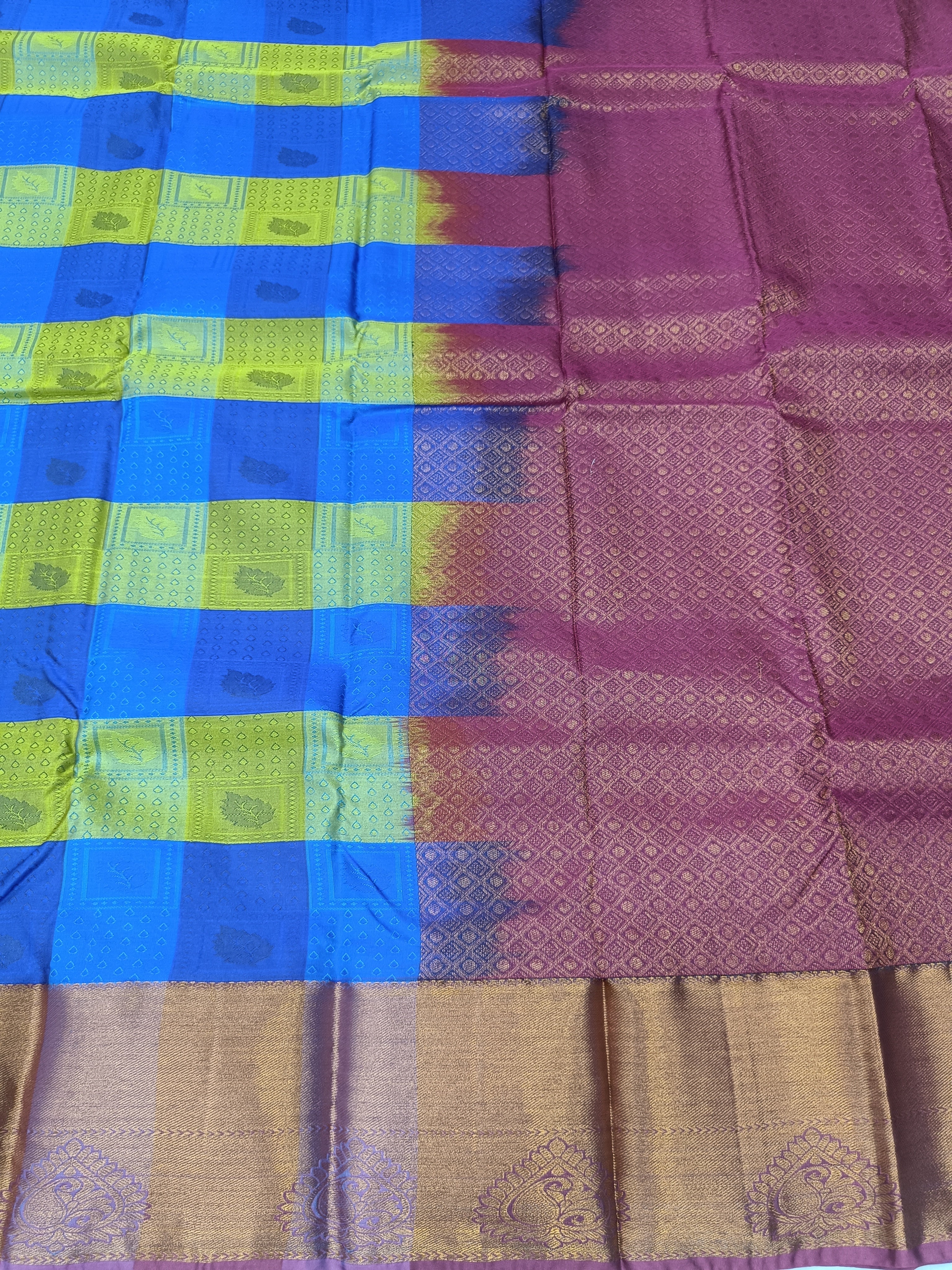 Kanchipuram silk saree close-up with blue and purple checks and tan zari border