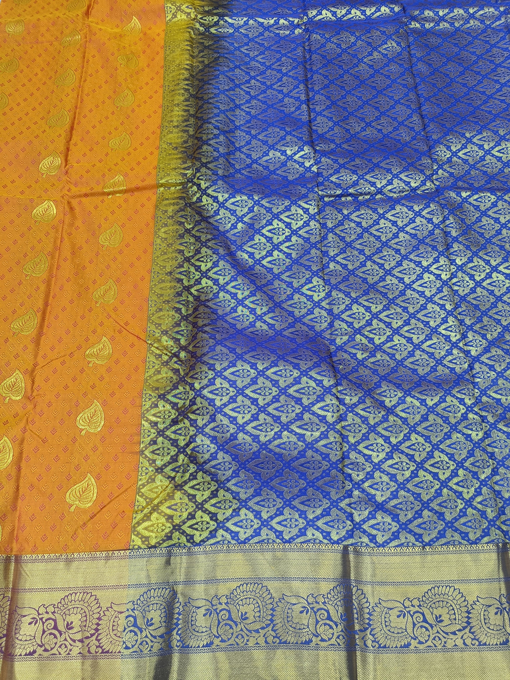 Mustard and blue silk saree with contrast border and detailed zari hem
