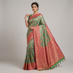 Banarasi silk saree worn by model, green body with pink border and gold motifs