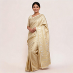 Cream and gold Banarasi silk saree draped with wide zari border and unstitched blouse