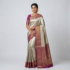Cream and maroon Banarasi silk saree with wide maroon border and gold zari pallu