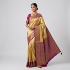 Banarasi silk saree on model, gold drape with maroon pallu and short-sleeve blouse