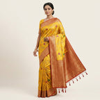 Woman wearing mustard yellow silk saree with red-gold border and floral motifs