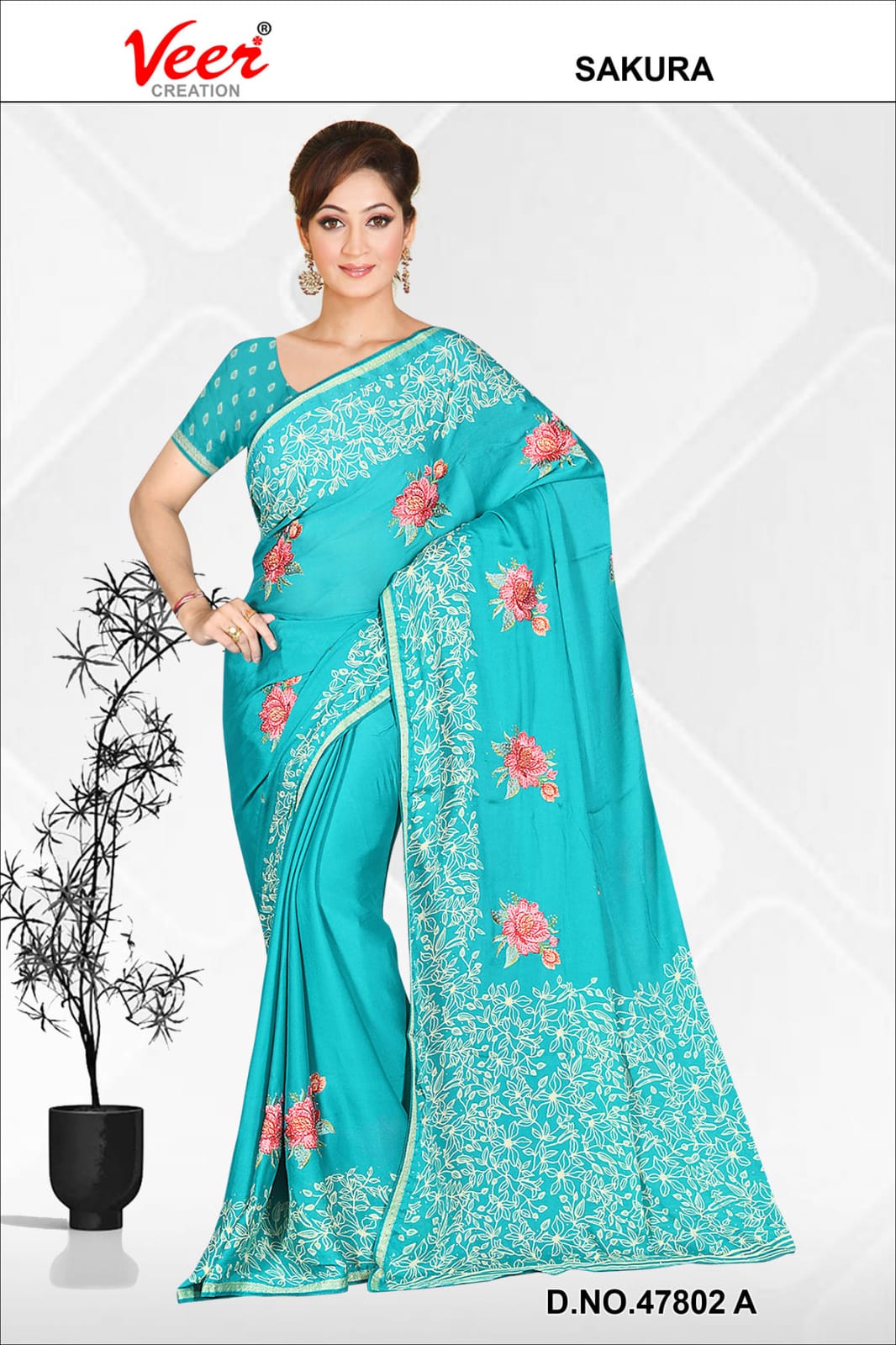 Teal saree with pink floral embroidery and leaf border, draped with blouse sleeves